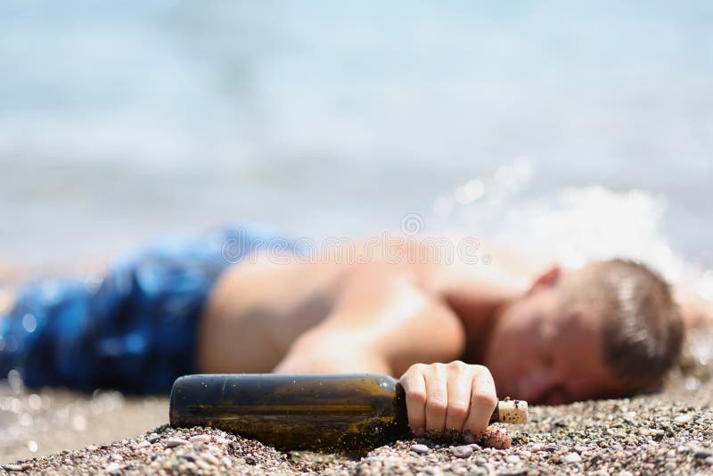 young-man-lying-beach-bottle-alcohol-drunk-tourists-concept-young-man-lying-beach-bottle-alcohol-244822491